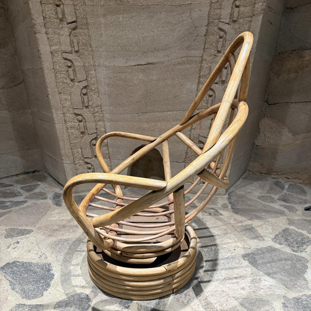 For your consideration, a swivel bucket lounge chair on stacked rattan bamboo pedestal base .Mid-Century period. USA circa...