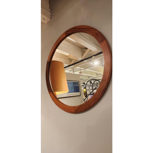 Beautiful round rosewood wall mirror. nice edge profile. marked on back.