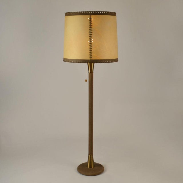 Elegant 1960's floor lamp in mid brown leather with large parchment leather shade creating a warm light. The hand made...