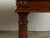 A Pair of Italian walnut console tables from the 19th century, with carved dentil molding and Doric columns. Created in...