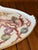 A charming hand-painted porcelain tray by artist Carol Psches featuring an elegant arrangement of seashells, coral,...
