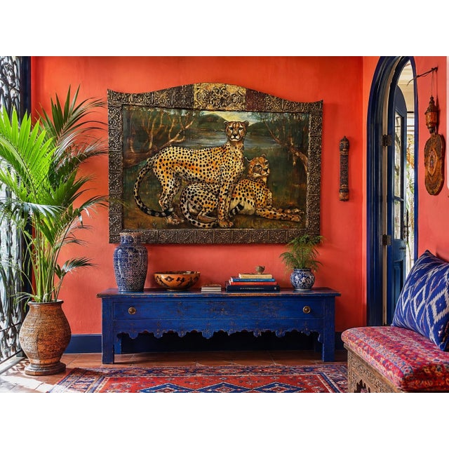 A commanding large-scale oil of two cheetahs at rest by a lake, signed lower right, in an extraordinary artist-constructed...