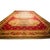 This circa 1840 Antique Aubusson rug is a monumental 14' x 25' European textile featuring a rich red ground and intricate...
