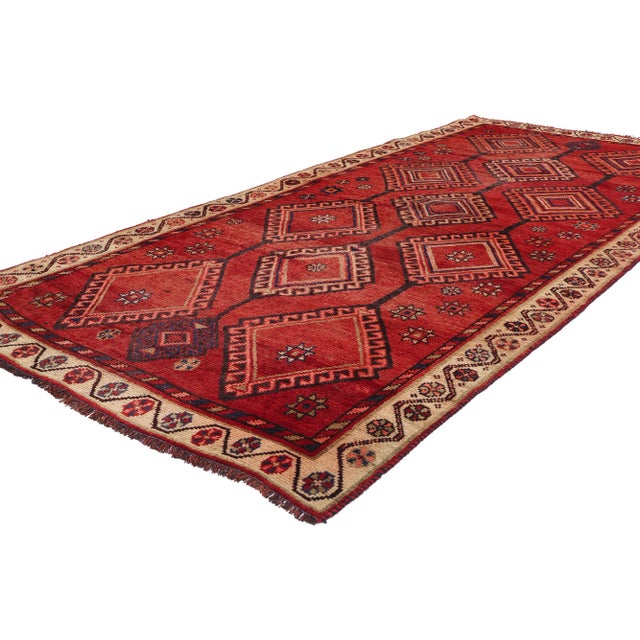 79079 Vintage Persian Shiraz Rug, 04'05 x 09'05. This hand knotted wool vintage Persian Shiraz rug is a masterful display...
