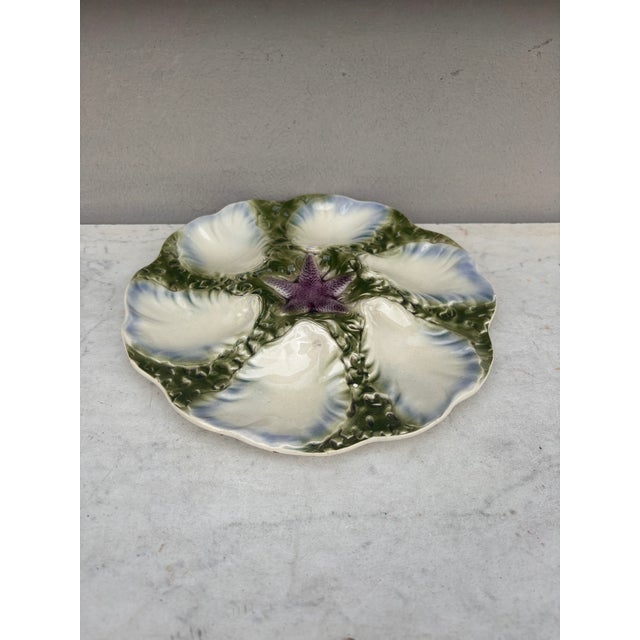 French Majolica plate with blue starfish with six wells blue and white surrounded by green seaweeds signed Digoin (East of...