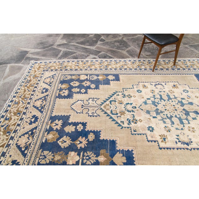A medallion design adorns this hand-knotted Oushak rug. Features colors such as beige for the base, dark blue, army green,...