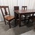Walker Edison Huntsman five-piece dining set in a distressed dark oak finish: the extendable trestle dining table with...