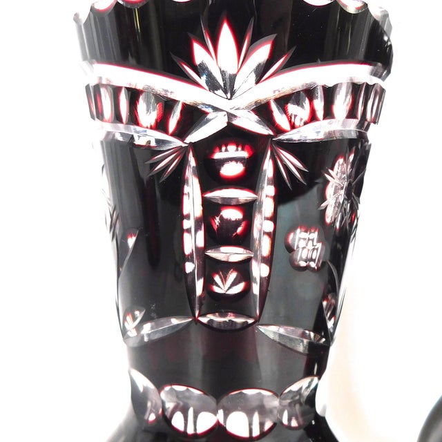 This is a pair of two red cut to clear vases. The vases are an exact match to each other. Each vase is 6 3/8 inches tall...