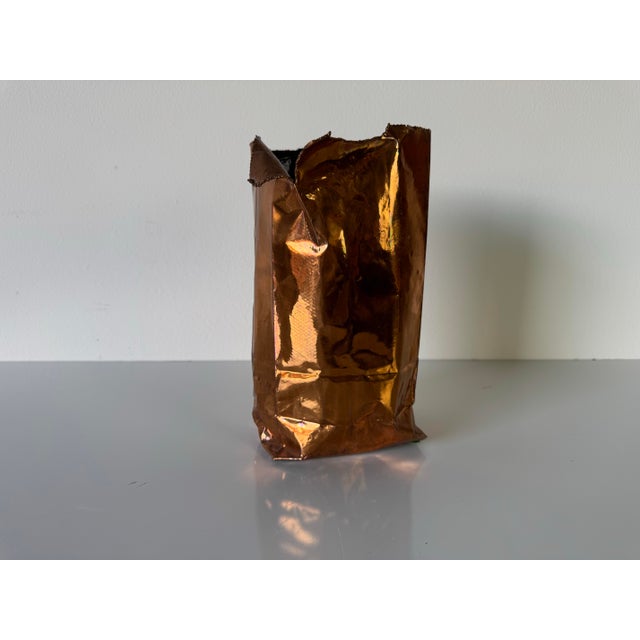 A bold and sculptural piece from the 1980s, this vintage bronze vase by California Bronze mimics the form of a crumpled...