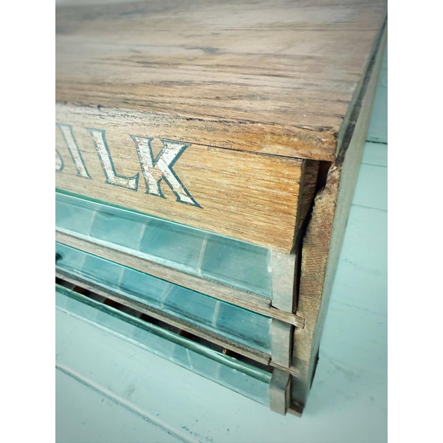 An authentic Belding’s Silk countertop thread cabinet, dating to the early 20th century, featuring its original painted...