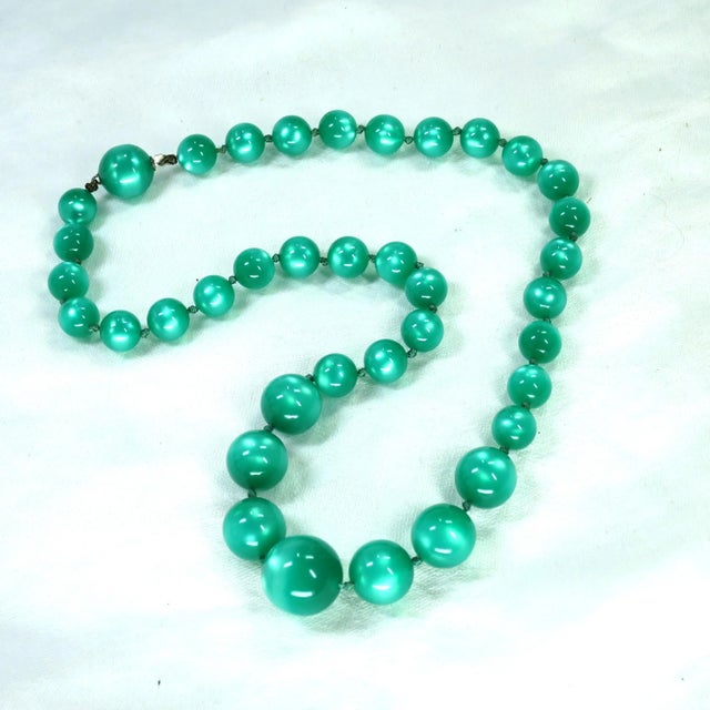 This is part of Chairish’s Costume Jewelry assortment. 1950s moonglow Lucite necklace, bracelet, screw-back earrings set....