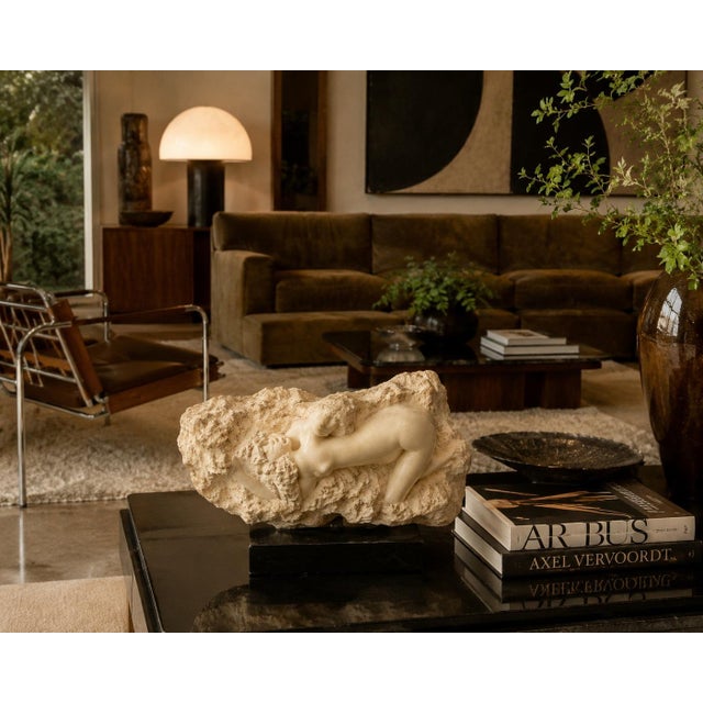 A dramatic Mid-Century Modern figurative sculpture by American artist Peggy Mach, depicting a reclining female nude...
