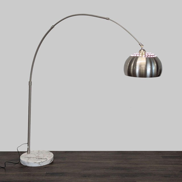 Modern EQ3 floor lamp features a brushed metal dome shade and sturdy marble base. Adjustable arc design allows you to...
