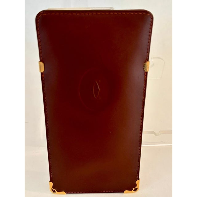 Authentic 1980s Cartier Burgundy Leather Eyewear Case – Made in France. A refined accessory from the celebrated Must de...