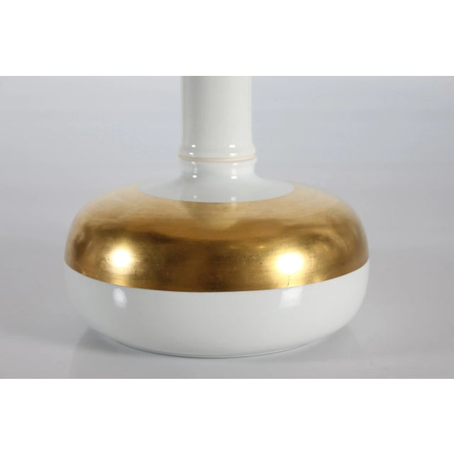 Tall vintage Royal Copenhagen table lamp made in the 1970s of white glazed faience decorated with a broad gilded band....