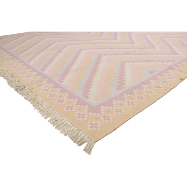 Vintage dhurrie area rug with pastel colors and bohemian style. Pale pastel hues and soft elegance bring harmony to this...