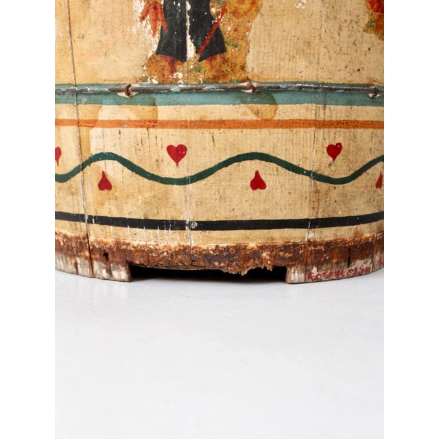 This is an antique painted wooden bucket. The painted yellow folk art bucket features red, blue, and green trim with...