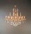 This large, oval crystal chandelier is designed in the Italian Baroque style with Rococo influences. Its curved arms, open...