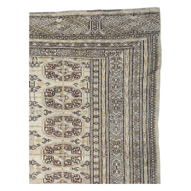 A vintage tribal Central Asian Turkoman accent rug handmade during the mid-20th century. Measures: 4' 4" x 5' 11".