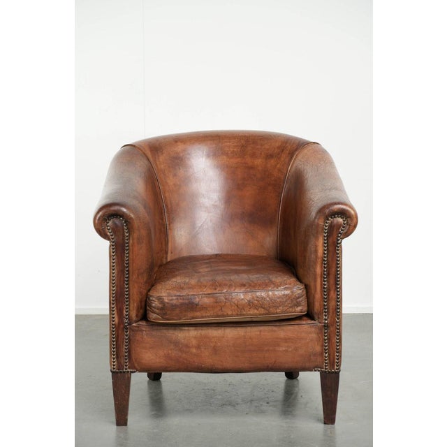Offered by ByThijs: this vintage sheepskin club armchair with a rich patina and a rugged appearance. : This vintage...