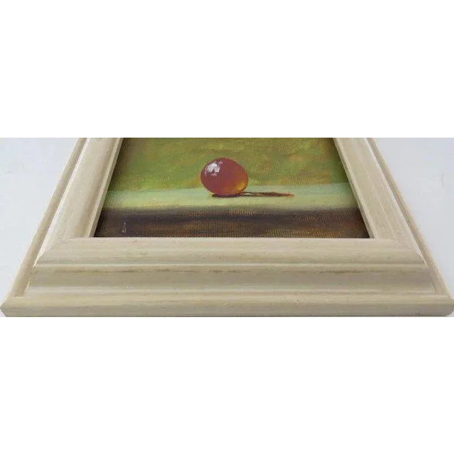 Small painting of an orange egg. Signed on side of frame. John Woods Denver 1997. 7" by 7". ARTIST’S BIO JOHN WOODS...