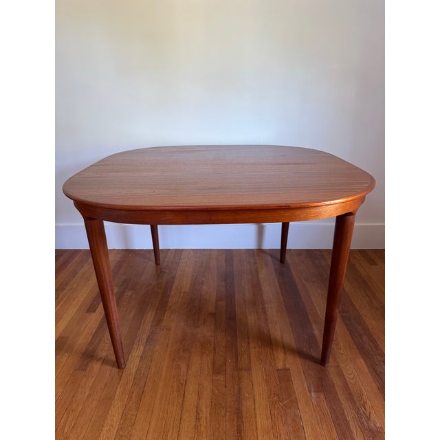 High quality Danish Modern Teak extendable dining table with solid organic turned legs Moreddi. Table is square with...