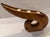 A sculptural three-candle holder, hand carved from two contrasting woods, a lighter honey-toned wood makes up the main...