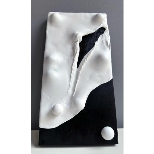 White foam-clay domino wall relief in mixed media on black wood panel, a tactile modular sculpture exploring form, void...