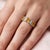 This striking ring showcases a vibrant combination of Citrine gemstones paired with brilliant white accent stones,...