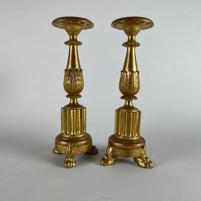 Pair of Carved and Gilded Wooden Candlesticks, 1800s. These two Italian circular candlesticks feature a fluted base...