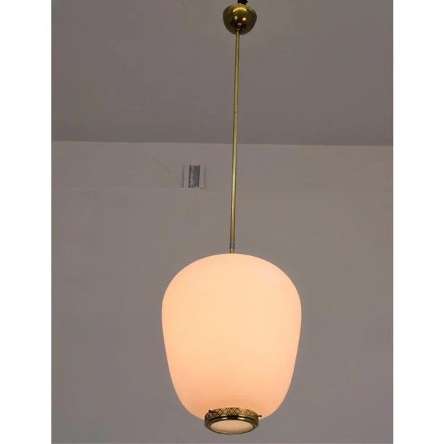 Opaline and brass suspension lamp, Italian production of the 1950s. Excellent condition, normal wear wear (see photos)....