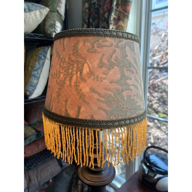 A lampshade handmade from a vintage Fortuny printed cotton, embellished with vintage beaded fringe. Measurements:top 7”...