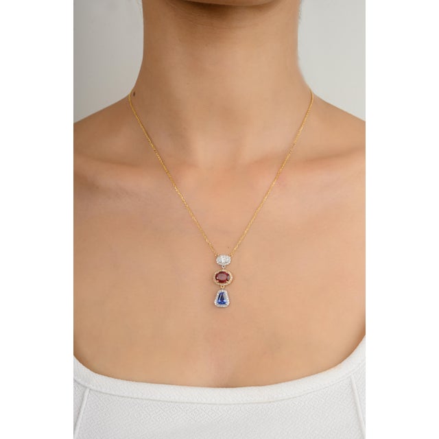 This stylish pendant necklace features a dazzling 18K gold setting, showcasing your choice of a vibrant pink or blue...
