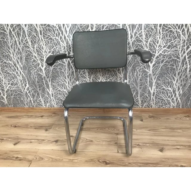 Chrome chair designed by Walter Knoll. Good condition, covered with eco-leather. Seat on springs, armrests on chromed...