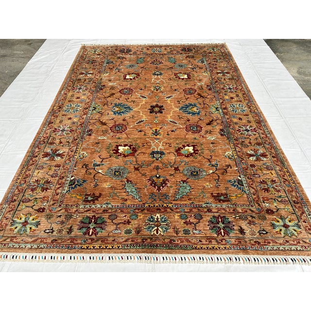 This hand-knotted Sultanabad rug features an elegant allover lattice of rosette palmettes in teal, burgundy, and gold,...