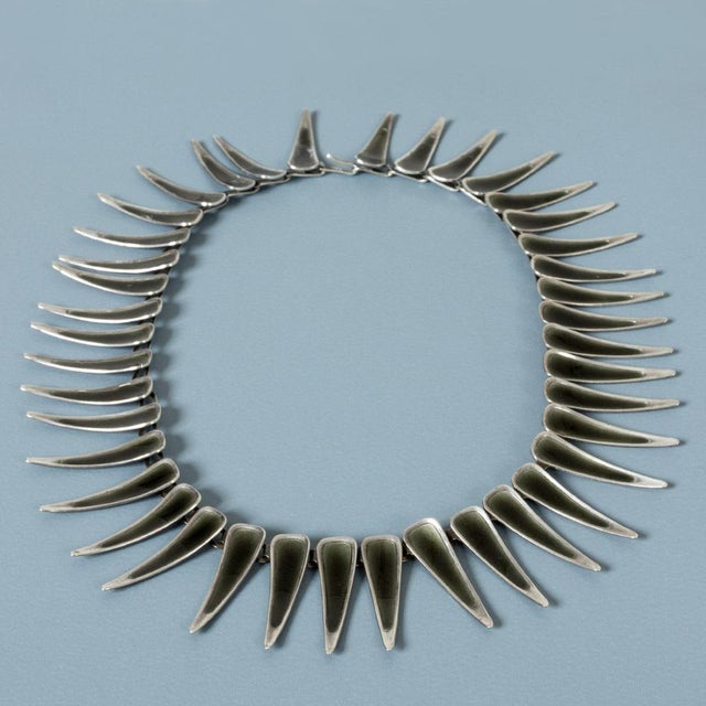 Silver collier from Michelsen, with long, concave pointy links. Decorated with dark green enamel. A very cool design that...