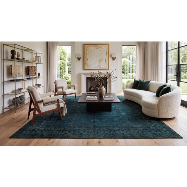 Elevate your living space with this striking modern overdyed wool area rug, crafted in a rich, moody palette of deep teal,...
