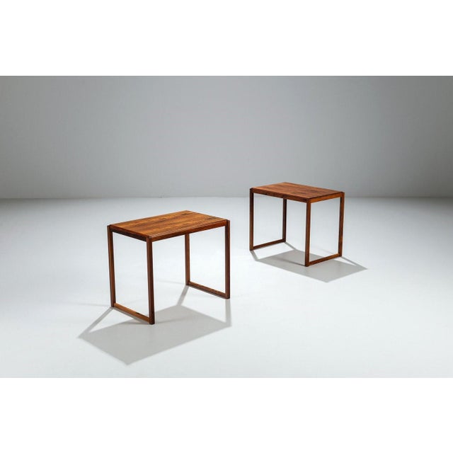 Beautiful pair of Danish mid-century side tables from the 1960s. They showcase the timeless beauty of richly grained...