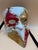 A striking pair of handcrafted Venetian-style masquerade masks, richly decorated in vibrant colors with elaborate raised...