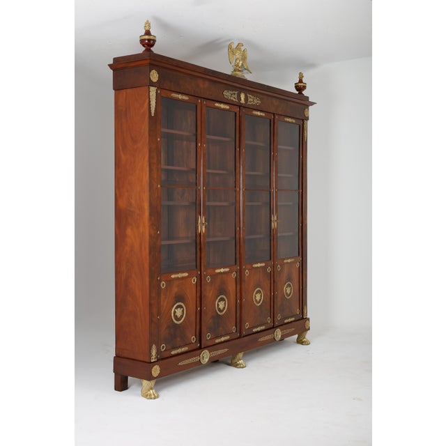 An exceptional and monumental four door Mahagony bookcase dating from the second half of the 19th century , distinguished...