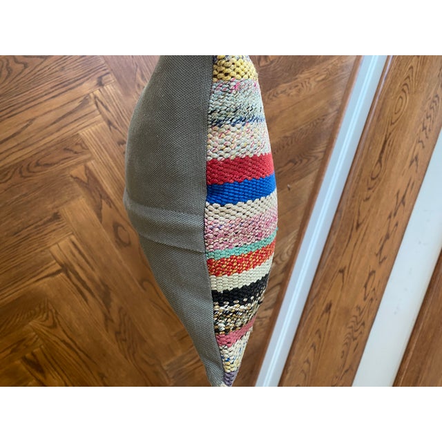 Decorative striped rug pillow with solid colored back. Zipper on back. Down insert included.