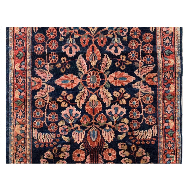 A beautiful early 20th century Persian Sarouk rug with a mirrored floral pattern with myriad floral clusters on the field,...