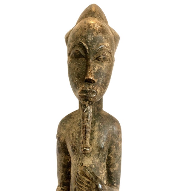 This African carved wood figure represents a male ancestor or spirit spouse statue. Standing at an impressive 26.5 inches...
