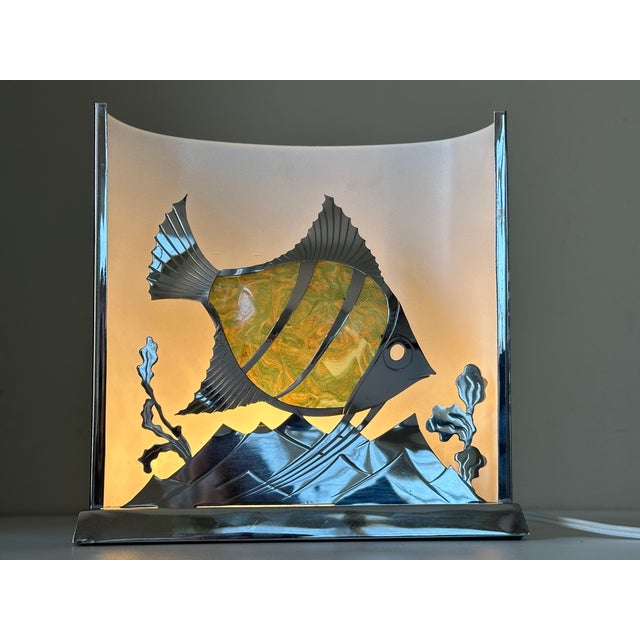 Very beautiful lamp from the 1950s in chrome-plated brass with a fish revealing light through its marbled plastic body...
