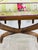 A charming vintage carved wood X-base stool or ottoman featuring elegantly curved, reeded legs joined by a central crossed...
