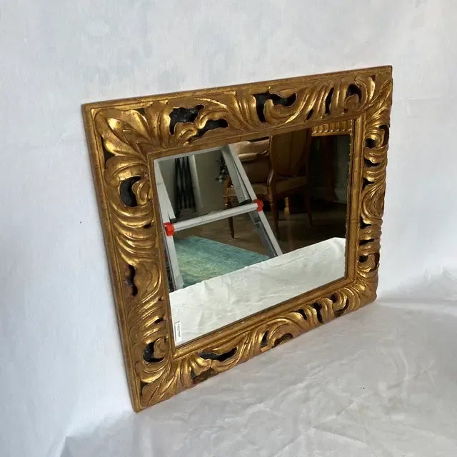 Hand carved and painted wooden gold gilded mirror. Created in Italy.