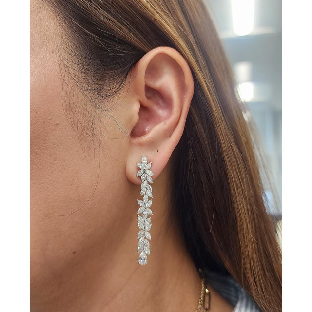 These exquisite drop earrings showcase 8.72 carats of natural marquise-cut diamonds, each with a pristine white hue. The...