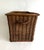 French wicker elongated basket with a handle at one end, perfect for sliding into a narrow space. A rich warm color way...