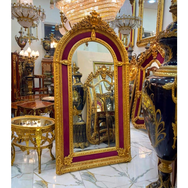 Elevate your interior with this grand French Rococo–style mirror, featuring a magnificent arched silhouette, richly carved...