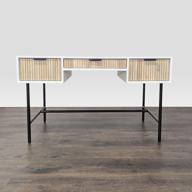 This West Elm desk features a modern design with a white frame, natural wood textured drawer fronts, and sturdy black...